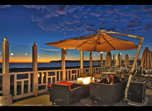 hoteldelcoronado sandiego sunset bar coronado people hotel california architecture vacation outdoor southern structure accommodations building balcony table luxury historical glamour tourism victorian samantoniophotography fire pit relaxing leisure evening