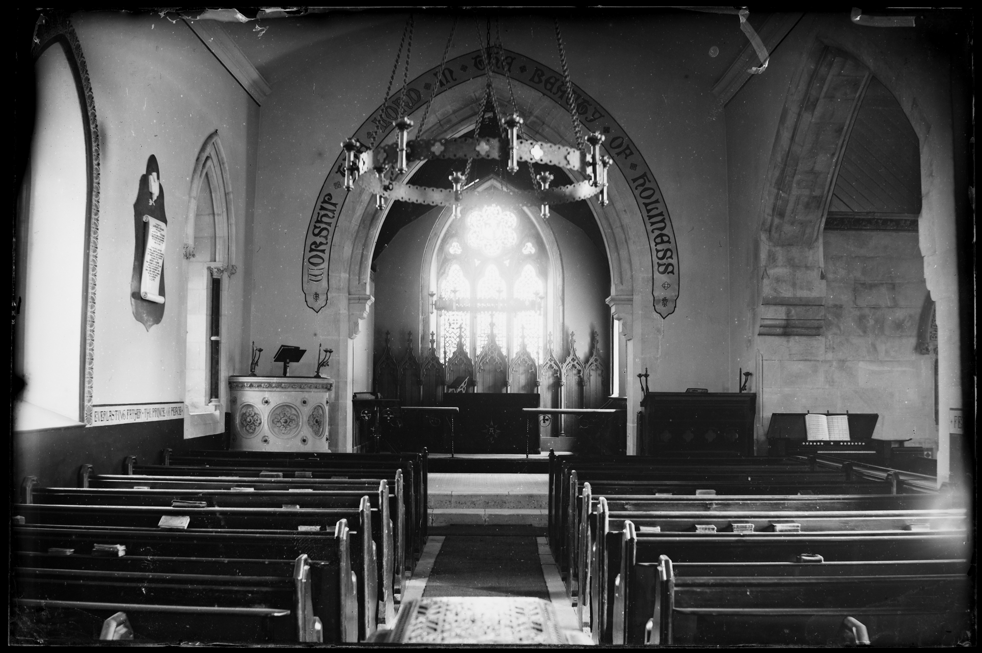 Church interior showing altar and pews. Script over altar reads 