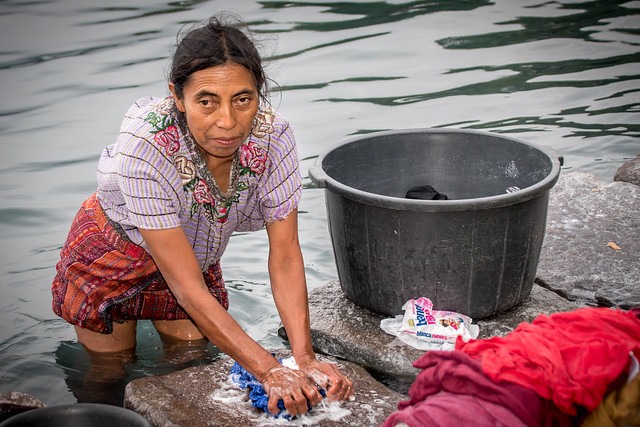 Guatemalan Maya woman washing clothes in Lake Atitlán.