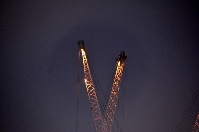 CRANE BALLET.   WORKING AT NIGHT ON THE LUANDA LOADING DOCK.  A BALLET OF CRANES LOADING A CONTAINER SHIP.  ANGOLA,  AFRICA.