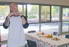 Trystan setting the tables for Home Library Service Christmas morning tea
