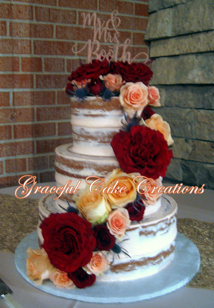 Elegant Semi Naked Wedding Cake with a Cascade of Fresh Bl 