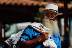 Man in White Hat with Sack, Carolina Del Principe