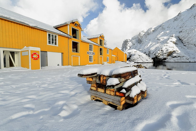 Old wooden port warehouse painted yellow-white casement windows. Nusfjord-Flakstadoya-Lofoten-Norway. 0505