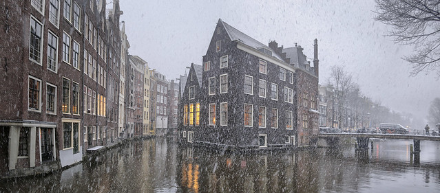 Snowflakes falling on the most idyllic and oldest canals of Amsterdam