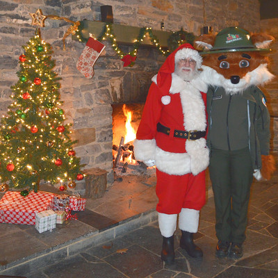 Ranger Fox and Santa Claus by the christmas tree and warm fire
