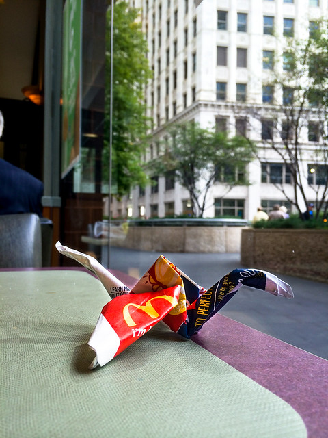 Origami made from fast food paper bag sitting on table at McDonalds