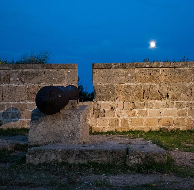 19th-century cannon, set in the wall of Acre near a sign commemorating Farhi after Siege of Acre