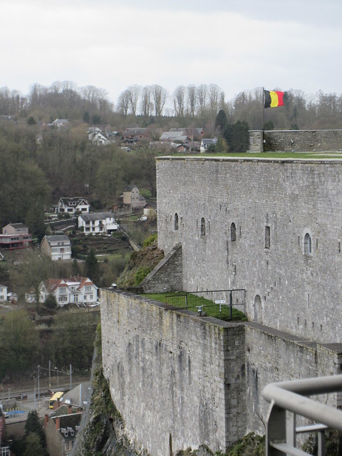 Citadel and Belgian flag, view to hillside across the river, Dinant, Belgium