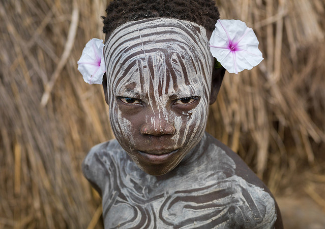 Mursi tribe boy wearing makeup and flowers, Omo valley, Mago National Park, Ethiopia