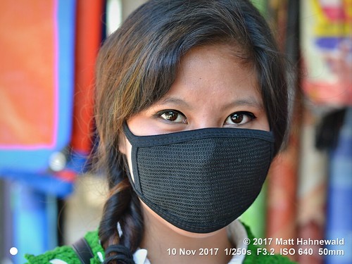 matthahnewaldphotography facingtheworld head face eyes catchlights beautifuleyes hair longhair facemask black mouthfacemask lifestyle beauty health safety pollution imphal manipur northeast india asia manipuri indian asian female girl young woman nikond3100 primelens 50mm street portrait outdoor posing authentic beautiful pretty fabulous protection headshot nikkorafs50mmf18g posingcamera colour person facecovering air closeup consensual oriental lookingatcamera seveneighthsview