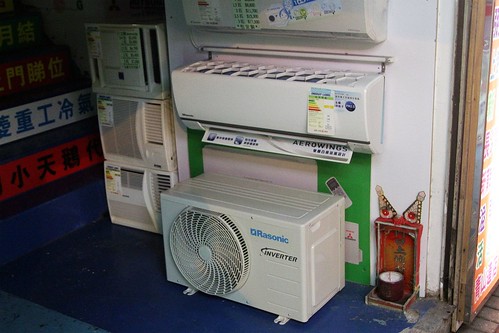 Split system air conditioner designed to be retrofitted onto a 'window box' air conditioner shelf