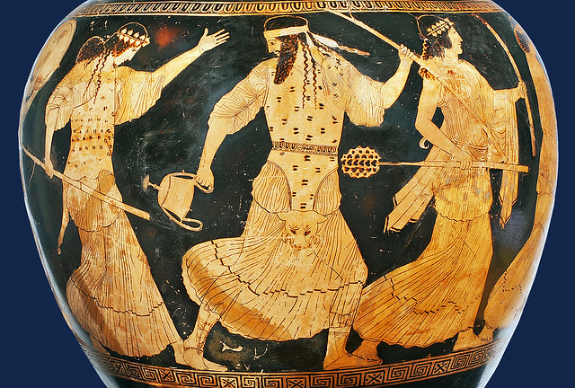 The Greek God of wine Dionysos with two dancing Maenads