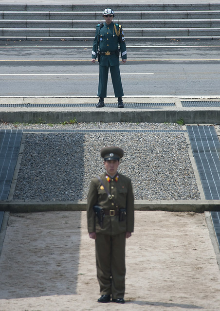 North Korean soldiers standing in front of the United Nations conference rooms on the demarcation line in the Demilitarized Zone, North Hwanghae Province, Panmunjon, North Korea