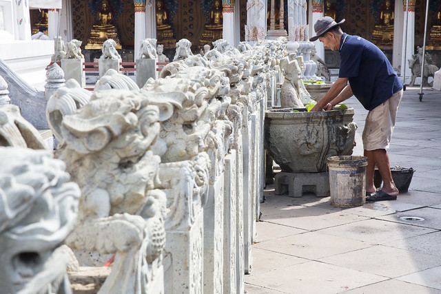 Old man working on maintenance of plants in Wat Arun - Bangkok
