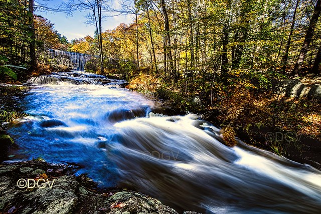 New England flowing water in the Fall with foliage.