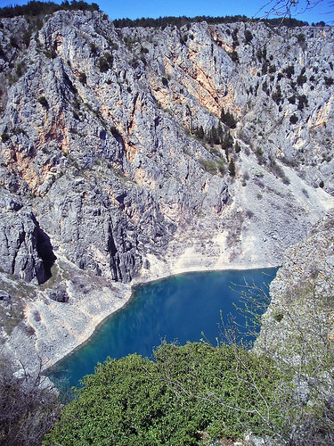 plavojezero imotski dalmatia croatia water cliff tree rock landscape sinkhole forest sky reflection bluelake