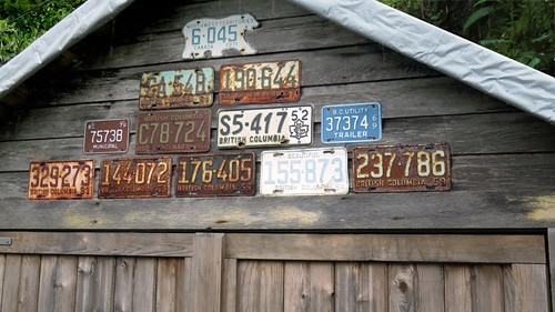 Old BC license plates nailed onto a garage in Tofino, Vancouver Island, Canada