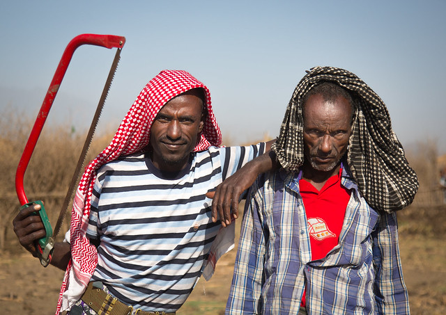 Oromo workers striking a pose with their saw, Amhara region, Artuma, Ethiopia