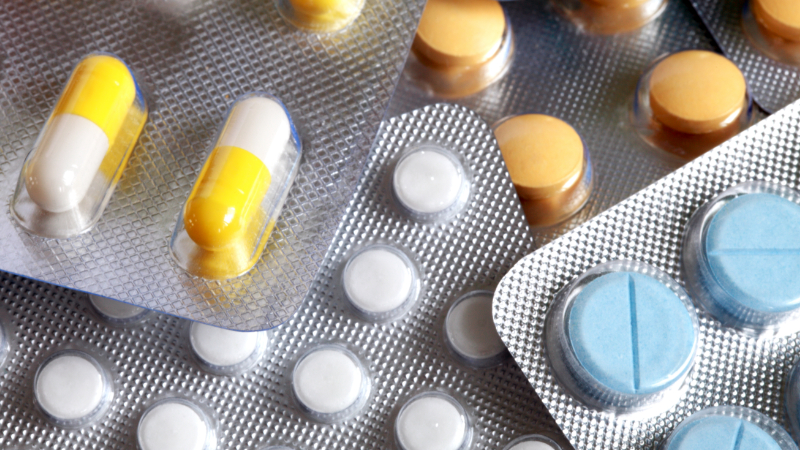 A closeup of various tablets in blister packs
