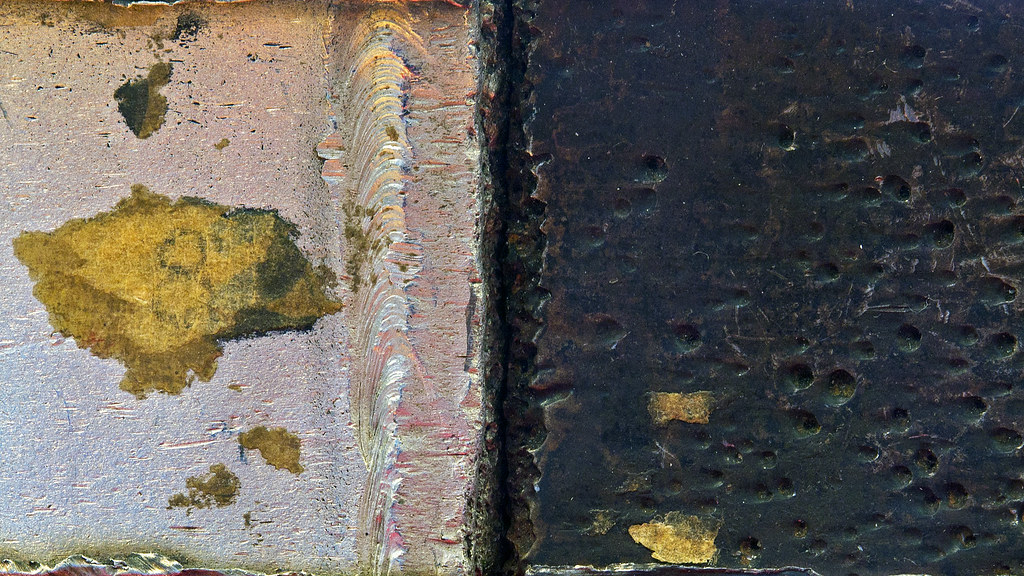 My photos for a school project: Close up: Corrosion induced cracking in metals. An example of galvanic corrosion in stainless steel and carbon steel welded together.