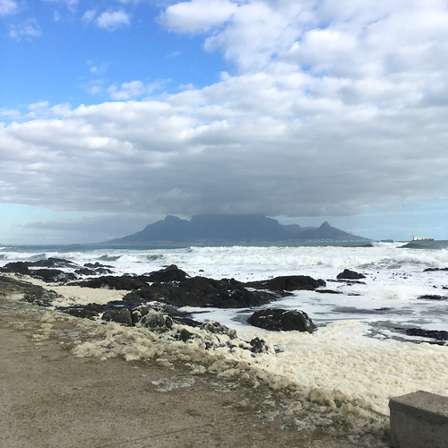 tablemountain sea ocean water foam waves mountain clouds cloudy capetown blouberg bloubergstrand blaauwberg westerncape southafrica iphonese iphone iphonography 2017 view scenery scenic sand beach