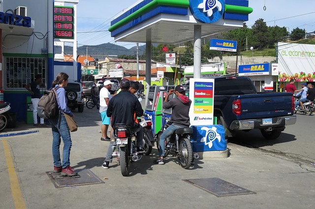 A stop with the motoconcho (motorcycle taxi) at a petrol station [Constanza / Dominican Republic]