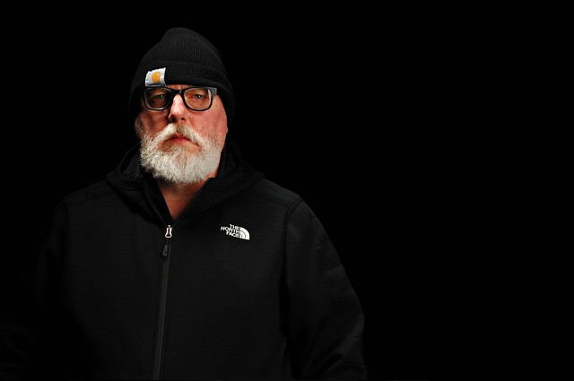 Another Self Portrait in a Black Hoodie against a Black Background