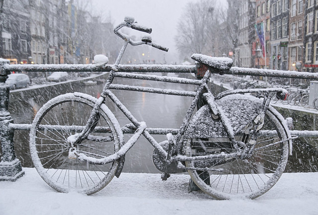 A wet brush of snowflakes on the bicycle