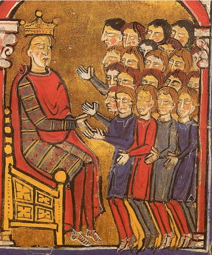 Alfonso the Battler, crowned and sitting on his throne, receives the tribute of the men of Perpignan