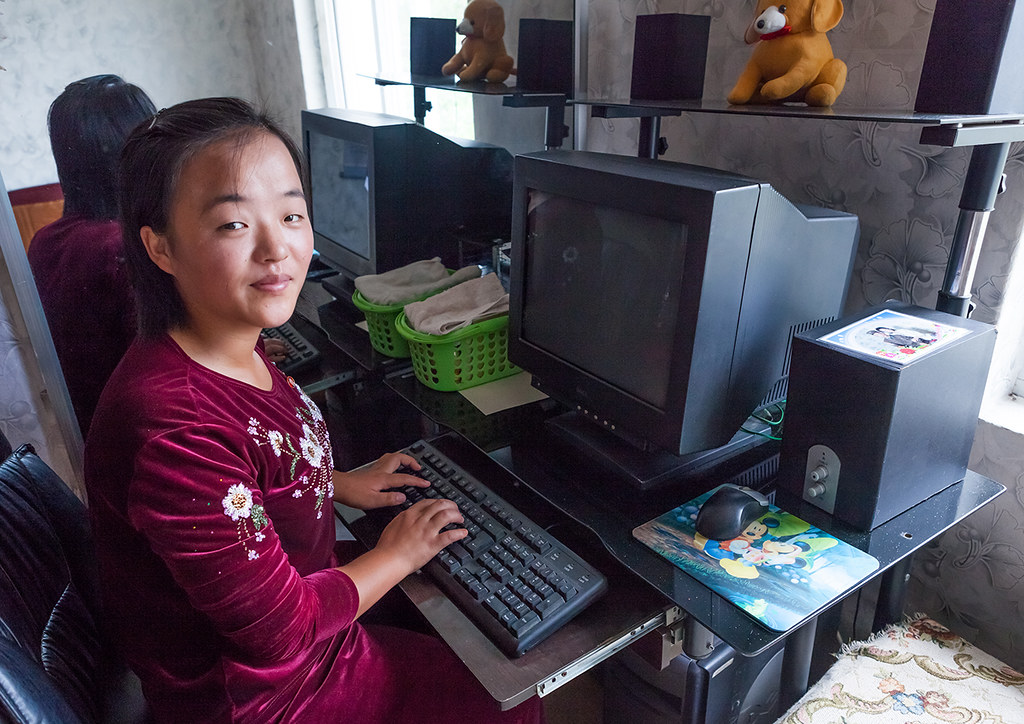 Portrait of a North Korean girl using a computer without electricty during a tourist visit, South Hamgyong Province, Hamhung, North Korea