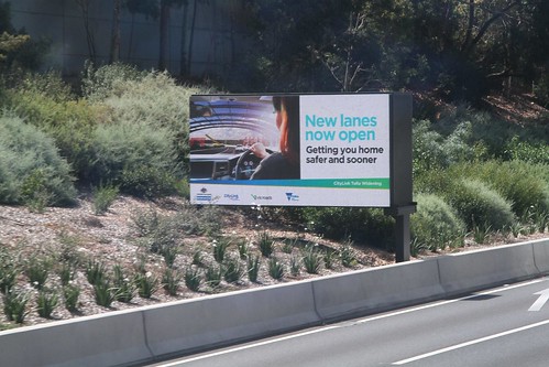 'New lanes now  open. Getting you home sooner and safer' propaganda from the CityLink Tulla Widening project