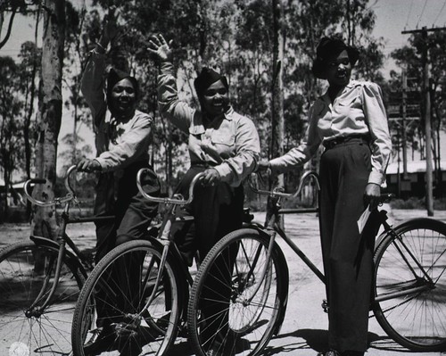 Nurses standing with bicycles