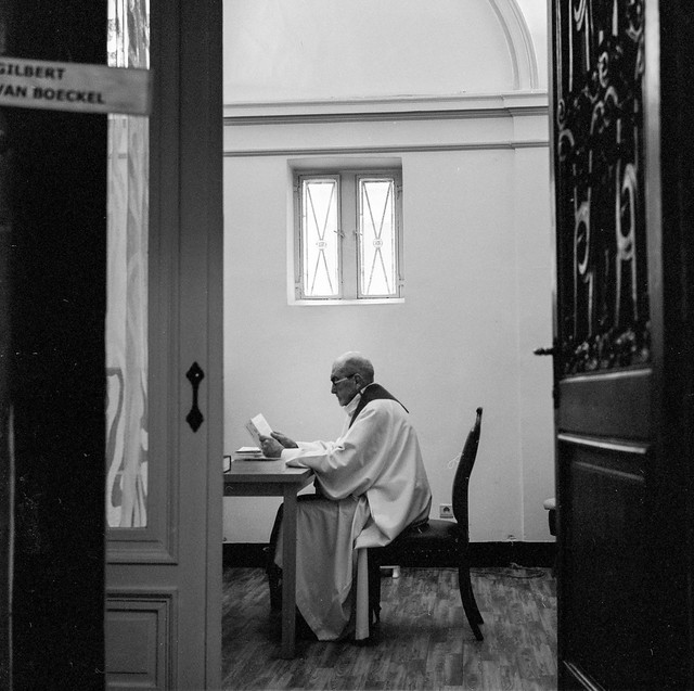 A priest reading at Notre-Dame du Finistere