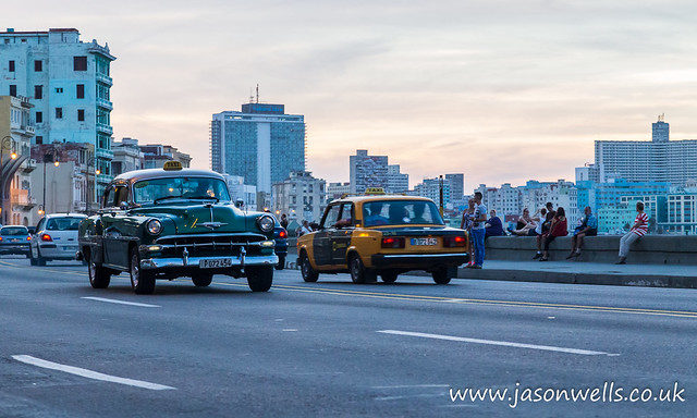 Green old timer on the Malecon at dusk