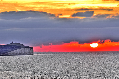 sunrise sunset dawn sun clouds sea cliffs lighthouse water sky headland 1000v40f ghe