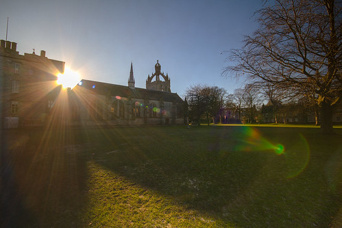 dazzling winter sun punches between Cromwell's Tower and King's College Chapel, University of Aberdeen, Aberdeen, Scotland.