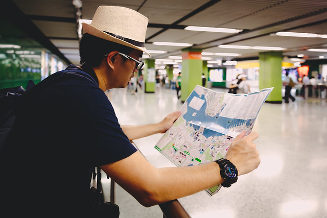 Tourist male with map in metro in Kowloon
