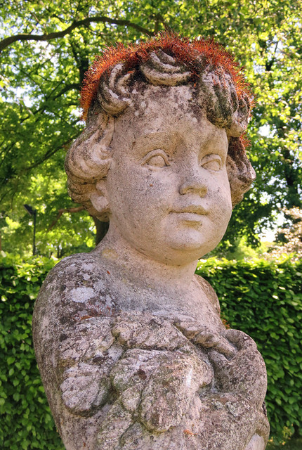 Statue of a Cherub with a Mossy Hairdo at Kasteel de Haar near Utrecht, Holland