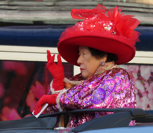 Regal lady in a red hat in the Chinese New Year Parade in Vancouver, Canada