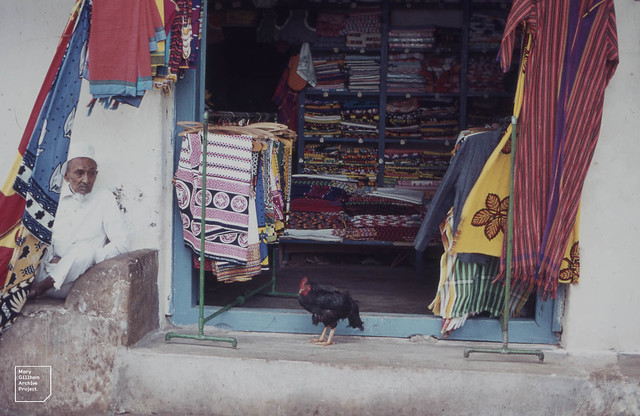 Hen shelters from rain in Indian stall. Malindi