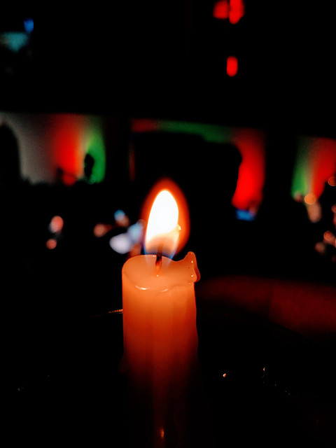 candle lit during christmas service at worship in church