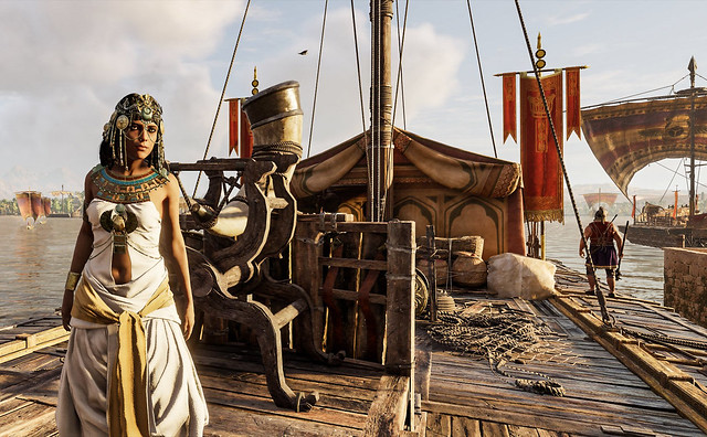 Cleopatra inspects one of her warships docked in ancient Alexandria in Assassin's Creed Origins Discovery Tour
