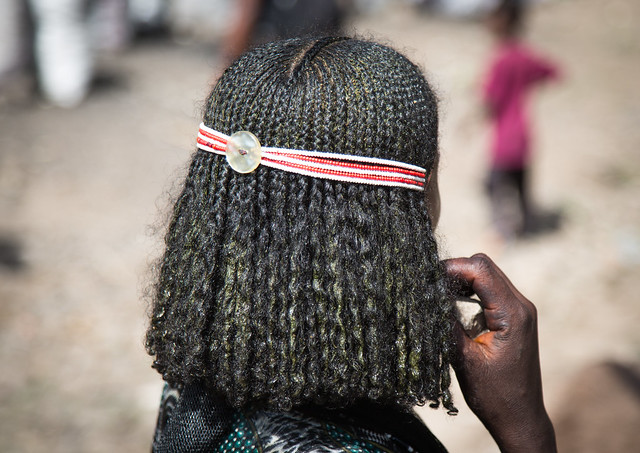 Oromo girl with traditional hairstyle and headband on a market day, Oromo, Sambate, Ethiopia