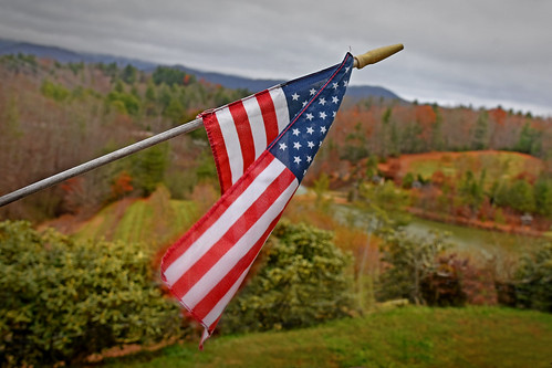 A small American flag flaps in a stiff wind at Saylor Orchard outside Bakersville in Mitchell County.