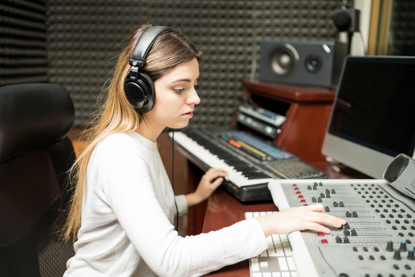 Female sound engineer composing music