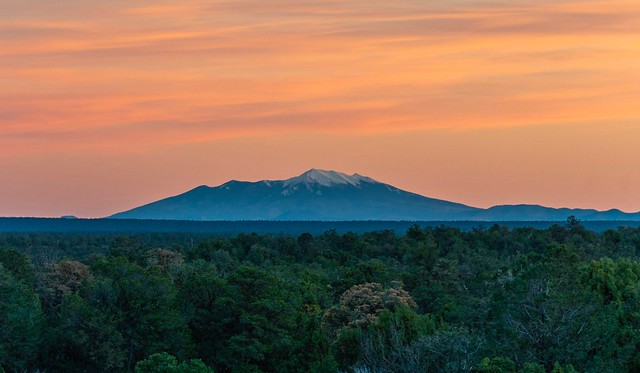 Humphreys Peak colored by sunset afterglow, visible from the South Rim of the Grand Canyon.