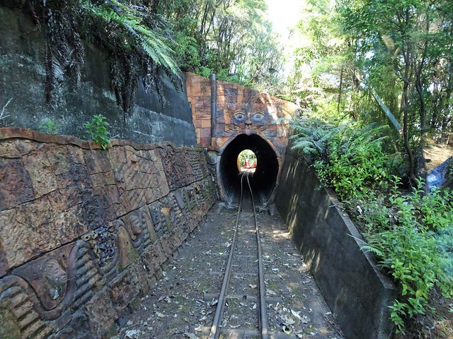 Coromandel. Tunnel entrance with a pottery cat on the Driving Creek Railway.