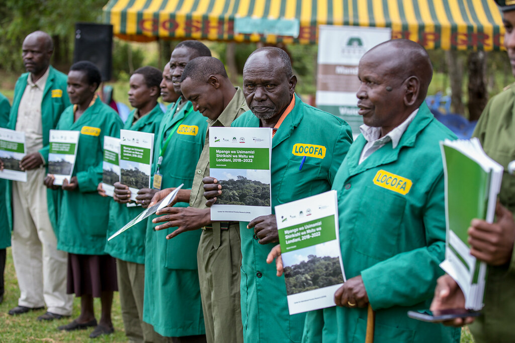 Members of Londiani Community Forest Association (LOCOFA) possing for a photo with their copies of the Participatory Forest Management Plan...