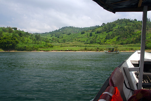 rwanda water lake kivu h2o shore boat transport landscape trees grass outdoor sky africa